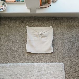 Strapless front twist tube top in beige; fits size M